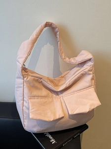 Quilted puffer tote bag in soft pink with wide shoulder straps and large front pockets