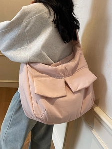 Pink quilted tote bag with large double front pockets shown on model for daily casual wear