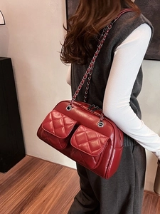 Vintage red quilted shoulder bag with chain strap and dual front pockets