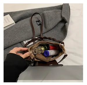 Detail view of deep brown leather bag interior showing capacity for makeup and phone