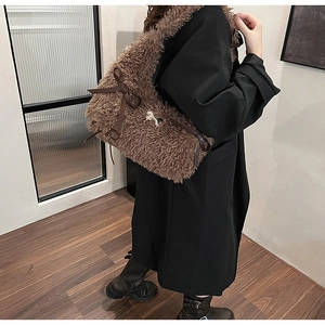 Brown fuzzy faux shearling tote bag with dark leather bows and golden pony charm pendant