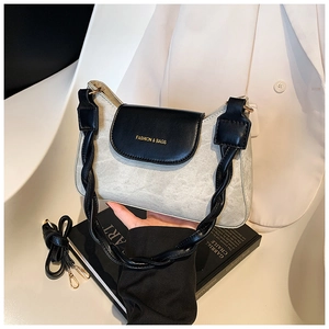 Detail of a retro contrast shoulder bag with textured leather and gold lettered flap