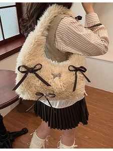 Plush shoulder bag with cute bows and butterfly charm shown in a lifestyle setting