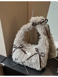 Cute gray plush faux fur shoulder bag with decorative brown leather bows for winter fashion