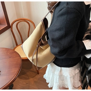 Detail of suede large tote bag with brown leather trim and knotted shoulder strap