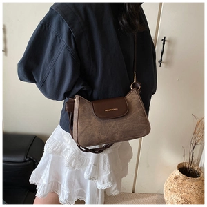 Close-up of vintage brown crossbody bag with gold Fashion & Bags logo lettering