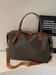 Large olive nylon travel tote bag with brown faux leather trim and adjustable strap