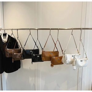 Detail view of minimalist shoulder bags in brown, black, camel and white matte leather