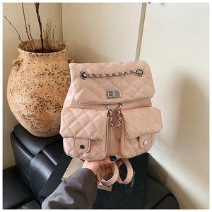 Detailed shot of pink quilted mini backpack with metal chain and glossy finish