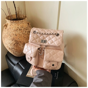 Detail view of pink quilted PU backpack with silver metal chains and twist locks