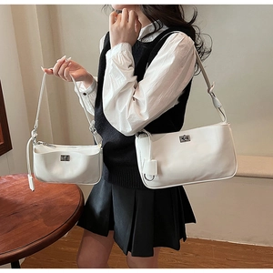 Comparison of small and large white leather shoulder bags with silver metal twist locks