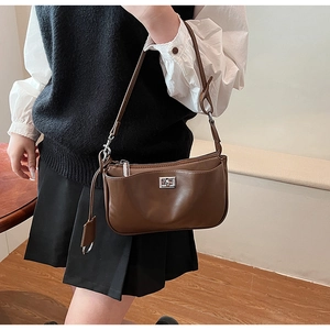 Detail of a dark brown vintage shoulder bag with a silver metal rectangular twist lock