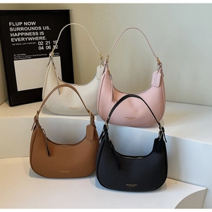 Detailed view of four crescent shoulder bags in white, pink, brown, and black leather texture