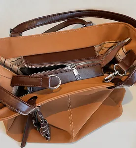 Close-up of smooth metal zipper and black and white striped lining inside the tote bag