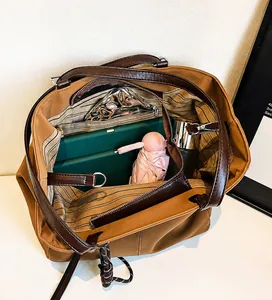Interior view of large leather tote bag showing spacious storage with striped lining
