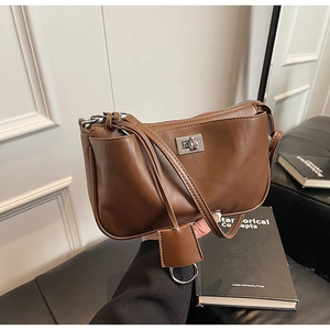 Detail shot of the vintage dark brown leather bag with a silver twist lock buckle