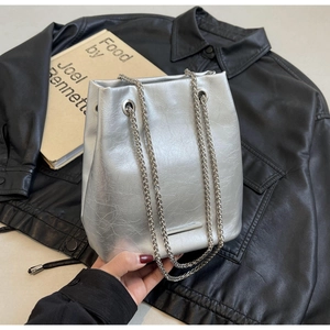 Close-up of silver bucket bag with metallic crinkled leather and chain straps