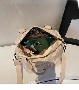 Internal view of beige nylon Boston bag showing large capacity and striped lining