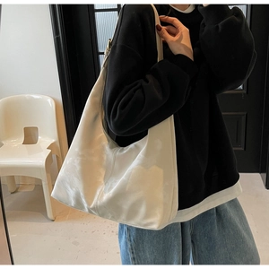 Detailed view of large white marble textured tote bag on shoulder with soft material