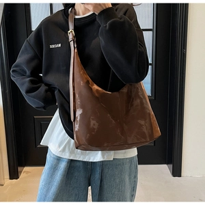 Detailed view of deep brown oversized hobo bag in glossy patent leather for women