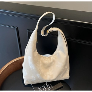 Detail of white marble-patterned hobo bag with adjustable gold-tone buckle hardware