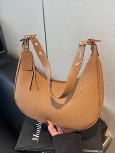 Chic brown woven dumpling hobo bag with adjustable leather strap and gold hardware