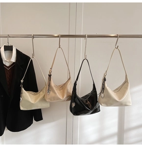 Detail of four versatile hobo bags in assorted colors with silver heart charms