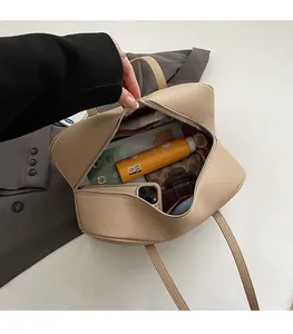Detail shot of the beige leather underarm bag interior showing large storage capacity
