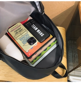 Internal view of black nylon backpack showing spacious compartments and storage capacity