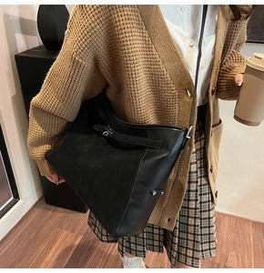 Retro black leather tote bag worn by a model in a warm autumn academic style setting