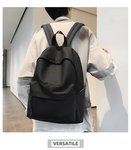 Rear view of model wearing minimalist black nylon backpack with large capacity