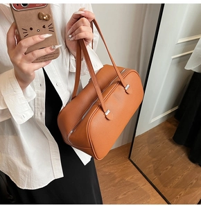 Caramel pebble leather shoulder bag in a stylish pillow shape with silver hardware details