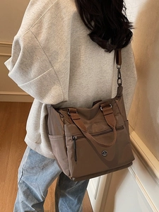 Brown large capacity waterproof tote bag with multiple pockets and cross-body strap
