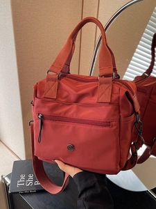 Women's brick red nylon tote bag with adjustable shoulder strap and large capacity