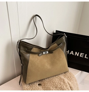Close-up of suede and leather patchwork tote bag with silver metallic twist lock