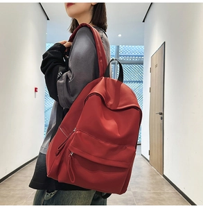 Detail of red high-capacity backpack with durable fabric and sturdy shoulder straps