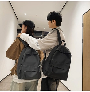 Minimalist high-capacity student backpacks in black and dark grey for daily commuting