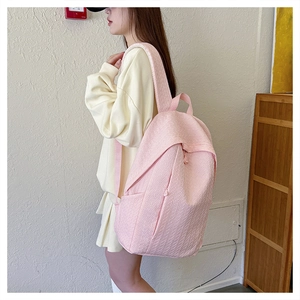 Close-up of pink large capacity backpack featuring unique embossed texture and side pocket