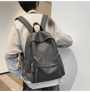 Close-up of durable gray waterproof nylon backpack with reinforced straps and pocket details