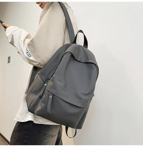 Side view of dark grey waterproof backpack showing wide shoulder straps and side pocket