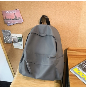 Close-up of minimalist grey waterproof nylon backpack with hidden zipper and side pocket
