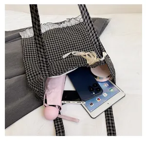 Lace-trimmed checkered tote bag showing spacious interior with daily essentials inside