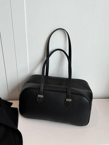 Minimalist black pebbled leather underarm bowling bag with silver metal hardware accents