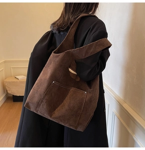Detailed view of dark brown corduroy tote bag featuring large capacity and front pocket