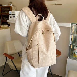 Minimalist beige woven backpack with textured herringbone pattern for students and travel