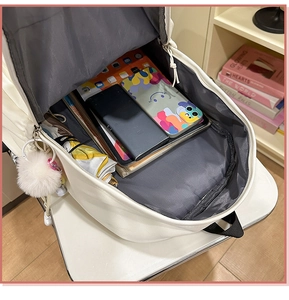 Interior view showing the spacious storage compartments of this white school backpack