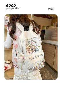 Detail of cute cream capybara backpack with plush charm and stylish graphic patterns