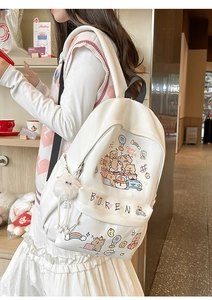 White backpack with cute Capybara cartoon pattern and plush charm on a model