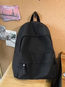 Minimalist black large capacity nylon backpack for school and daily commuting