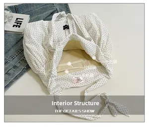 Top view of white polka dot canvas tote bag showing interior main compartment and pockets